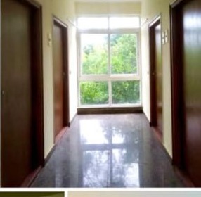 ISI Guest House — polished granite corridor with picture window